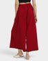 Red wide-leg pants worn by a person on a white background