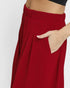 Red pants with a hand in the pocket on a white background