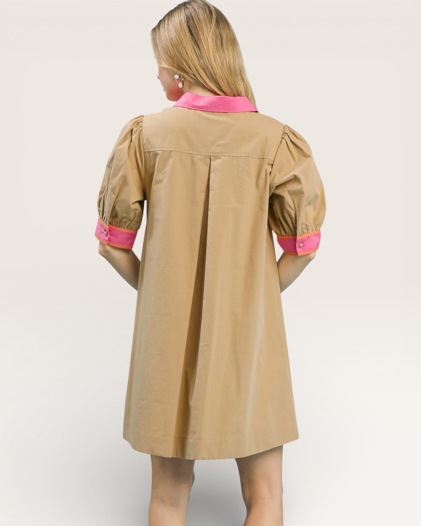 Beige dress with pink accents on a white background