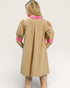 Beige dress with pink accents on a white background