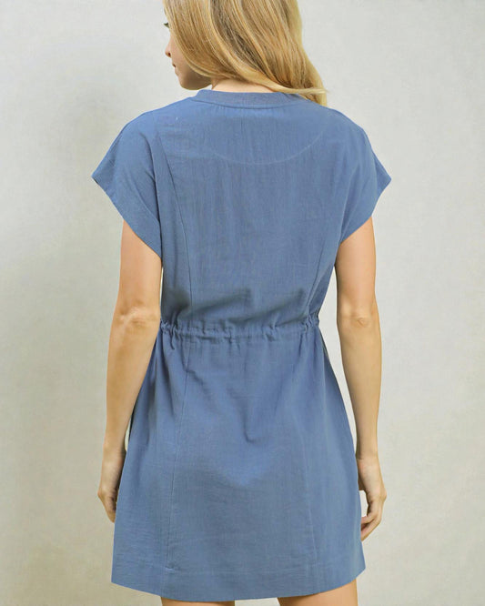 Blue dress worn by a person on a plain background