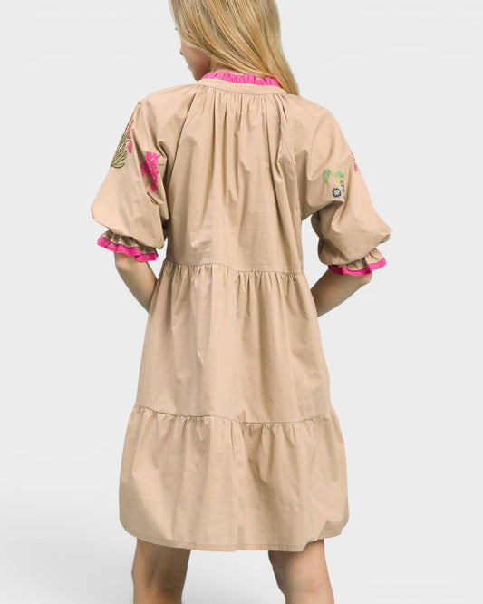 Beige dress with pink accents on a white background