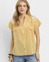 Woman wearing a yellow checkered blouse with lace details on a white background
