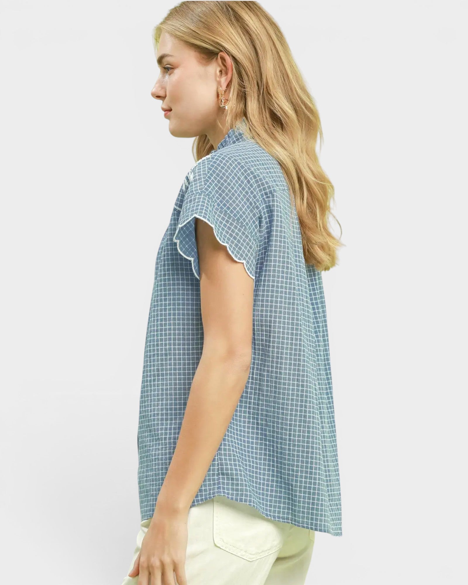 Woman wearing a blue checkered shirt on a white background