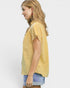 Woman wearing a yellow checkered blouse with ruffled sleeves on a white background