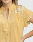 Yellow checkered blouse with floral embroidery on a white background