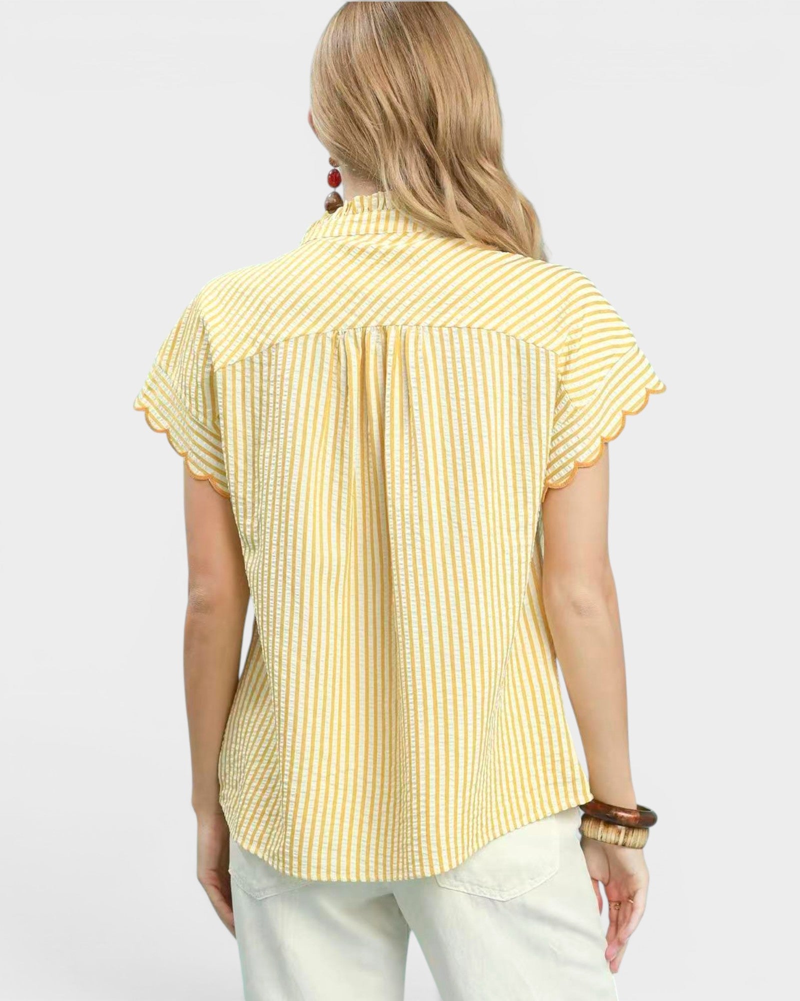 Woman wearing a yellow striped shirt on a white background
