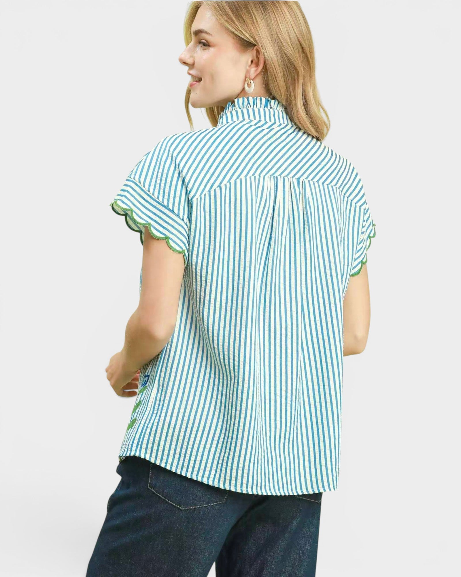 Woman wearing a green and white striped shirt on a white background