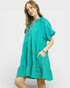 Woman wearing a teal dress on a white background