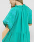 Green dress with floral pattern on a plain background