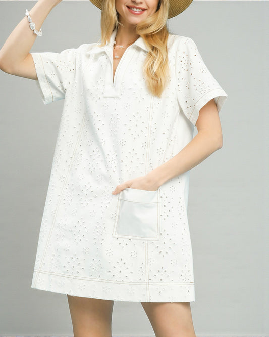 Woman wearing a white dress with a subtle pattern on a gray background