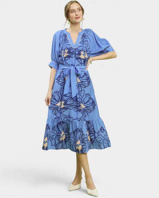 Woman wearing a blue floral dress on a white background