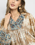 Woman wearing a patterned dress with a neutral background