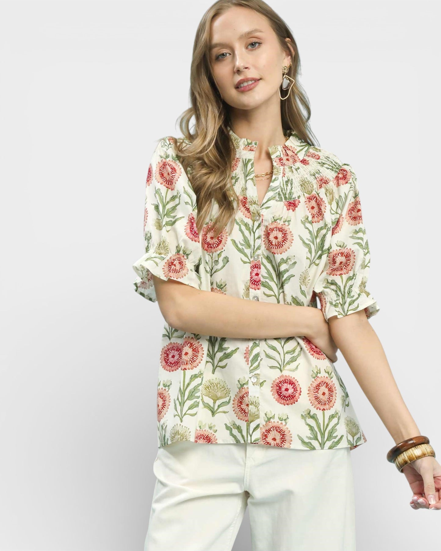Woman wearing a floral blouse with a plain background