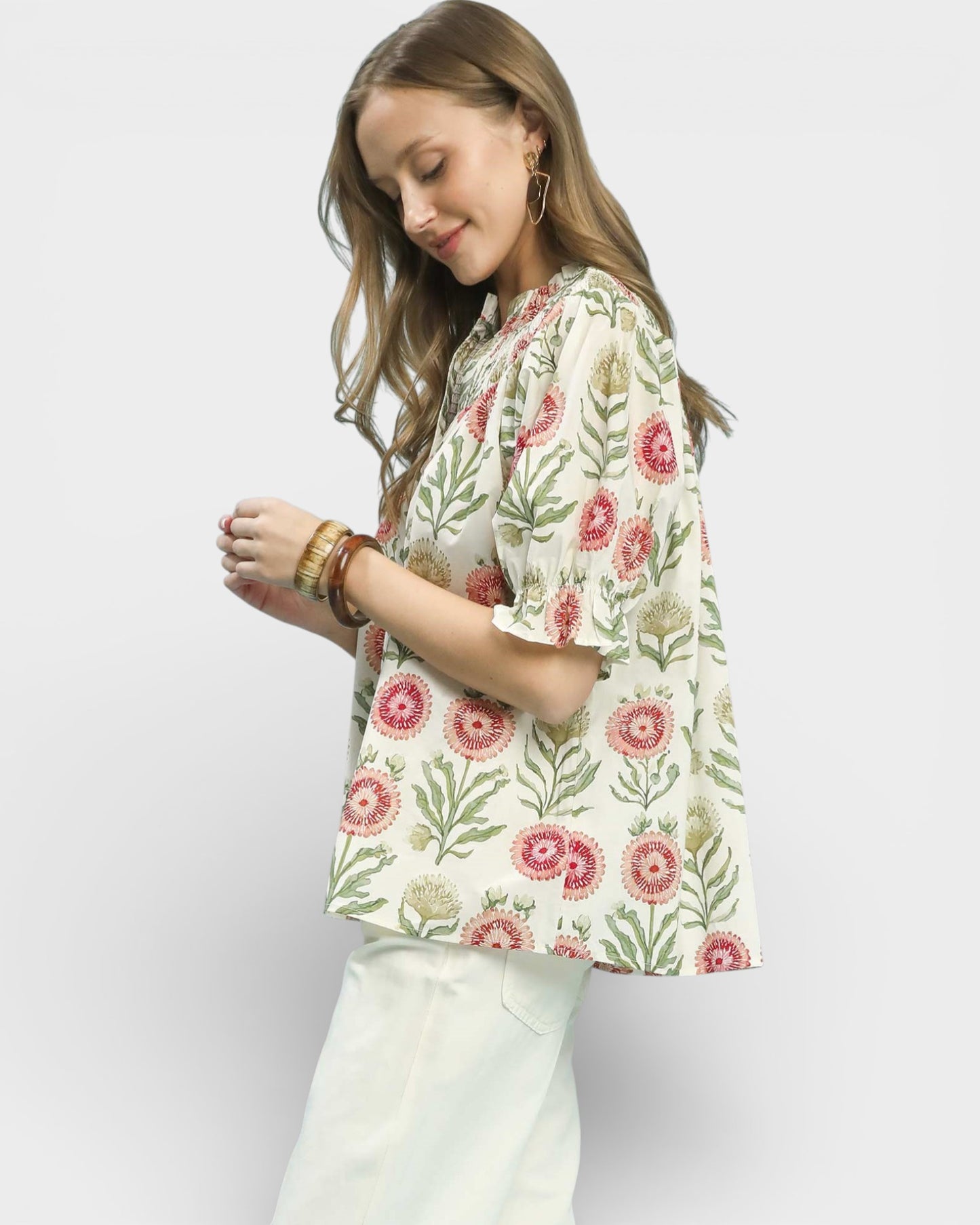 Woman wearing a floral blouse with a plain background