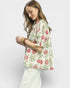 Woman wearing a floral blouse with a plain background