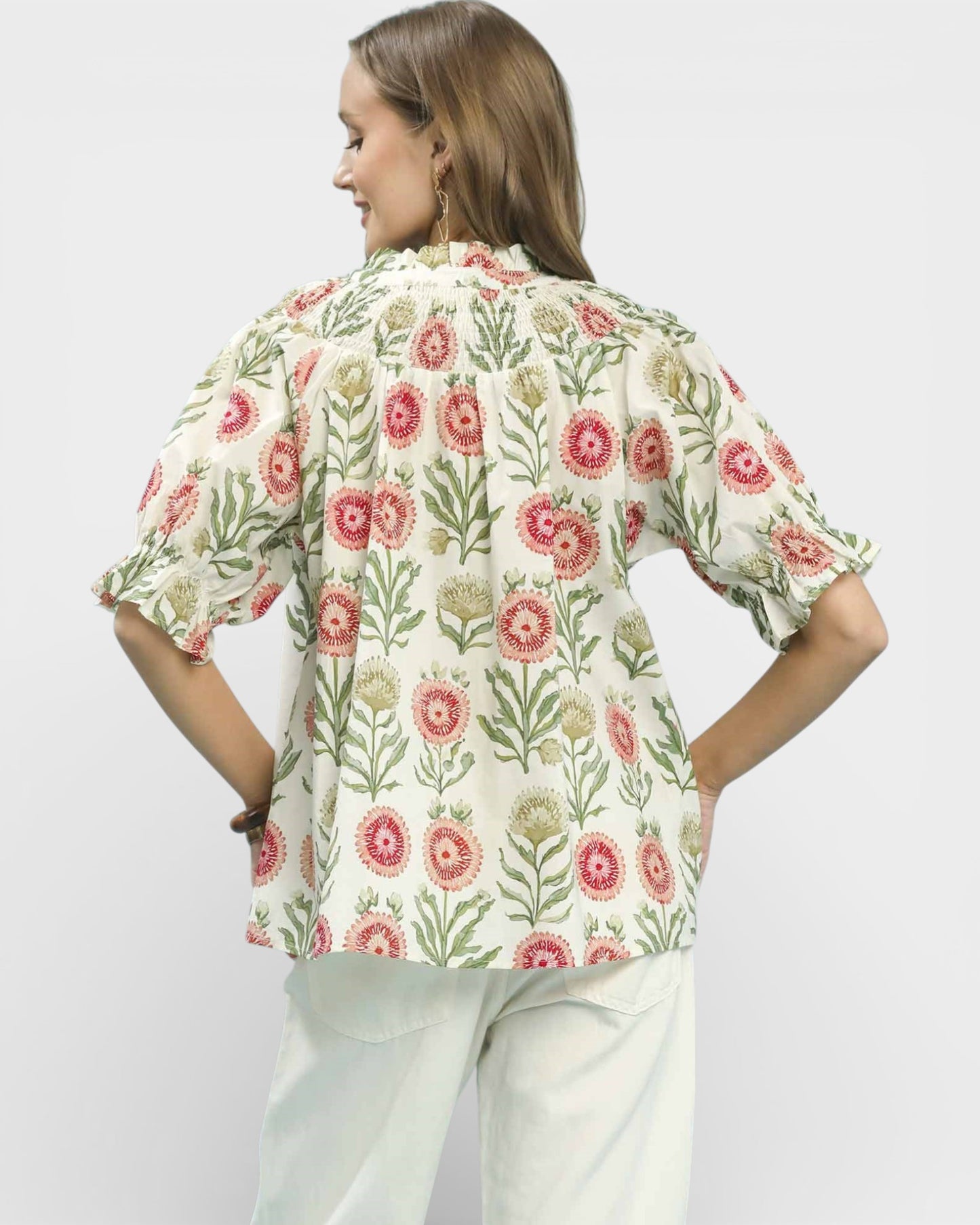 Woman wearing a floral blouse with a white background