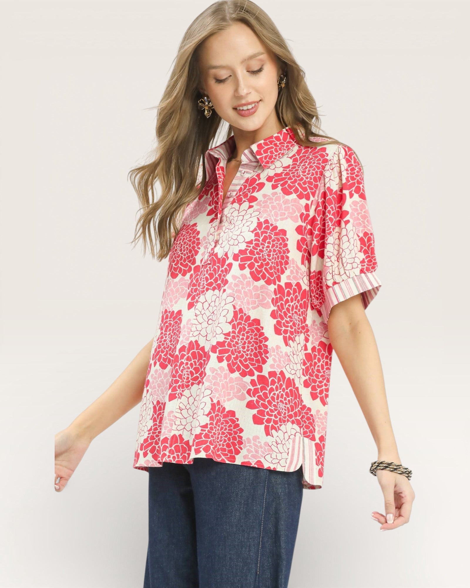 Woman wearing a pink floral blouse with a white background