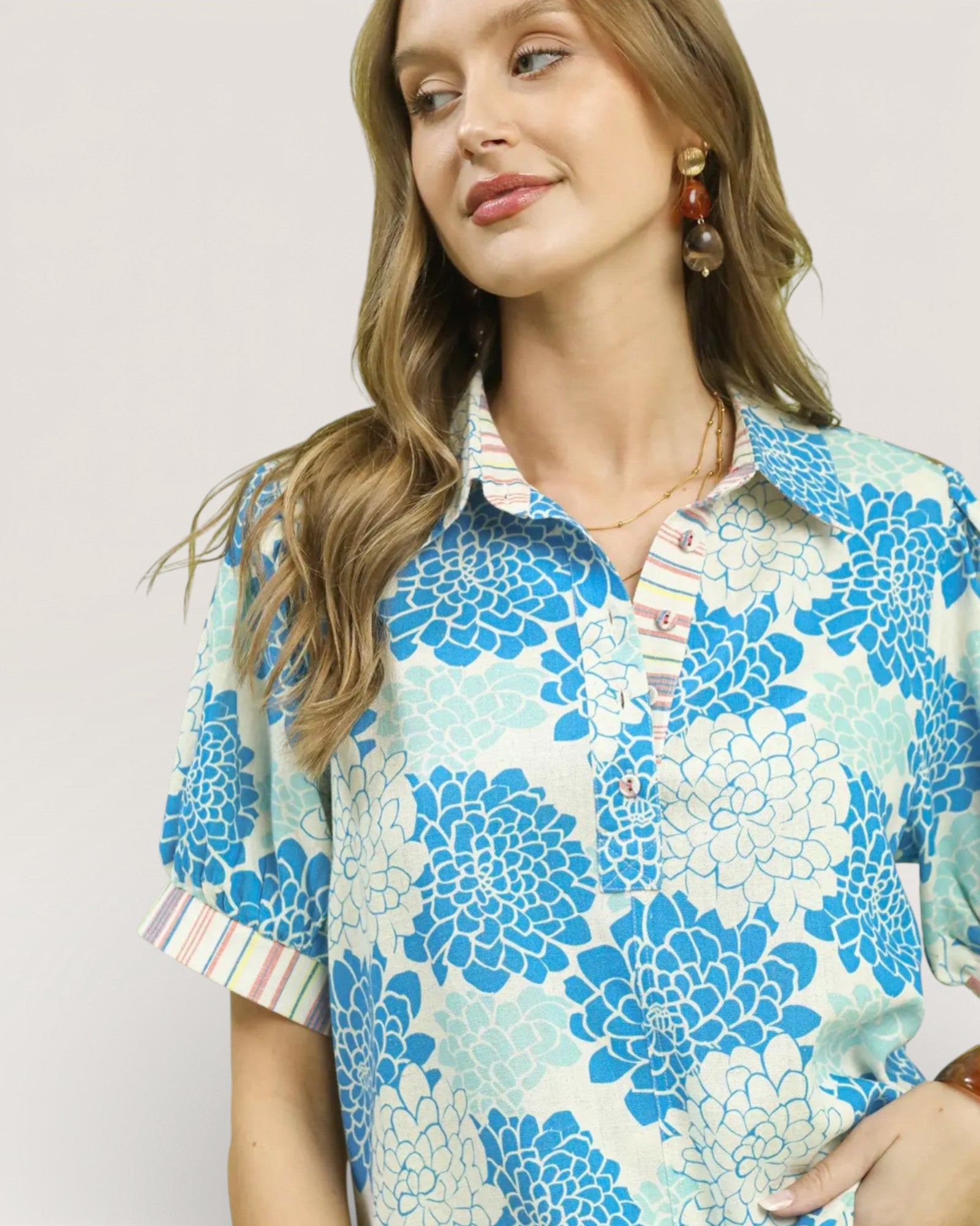 Woman wearing a floral blouse with a plain background