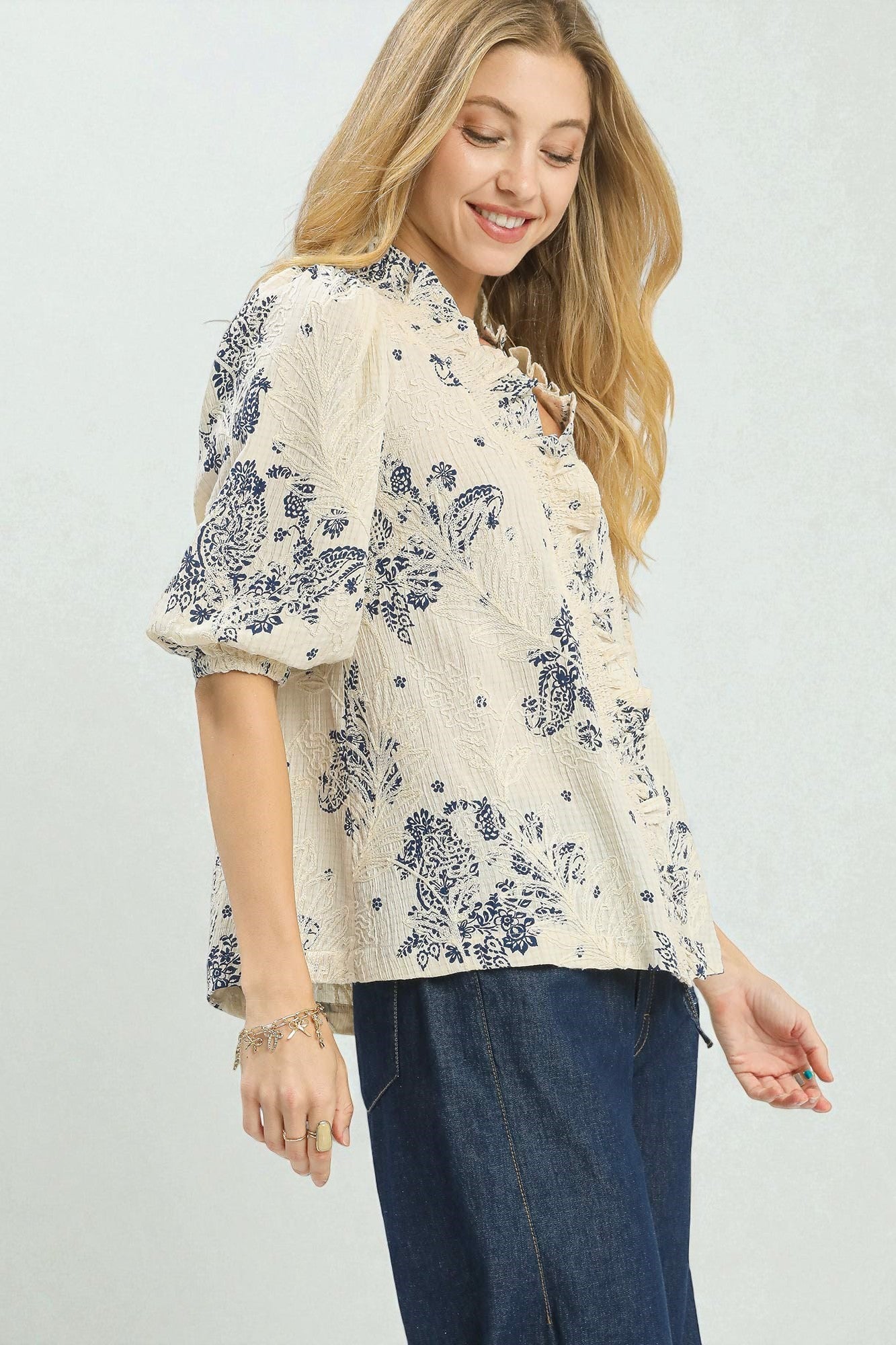 Woman wearing a floral blouse with a plain background