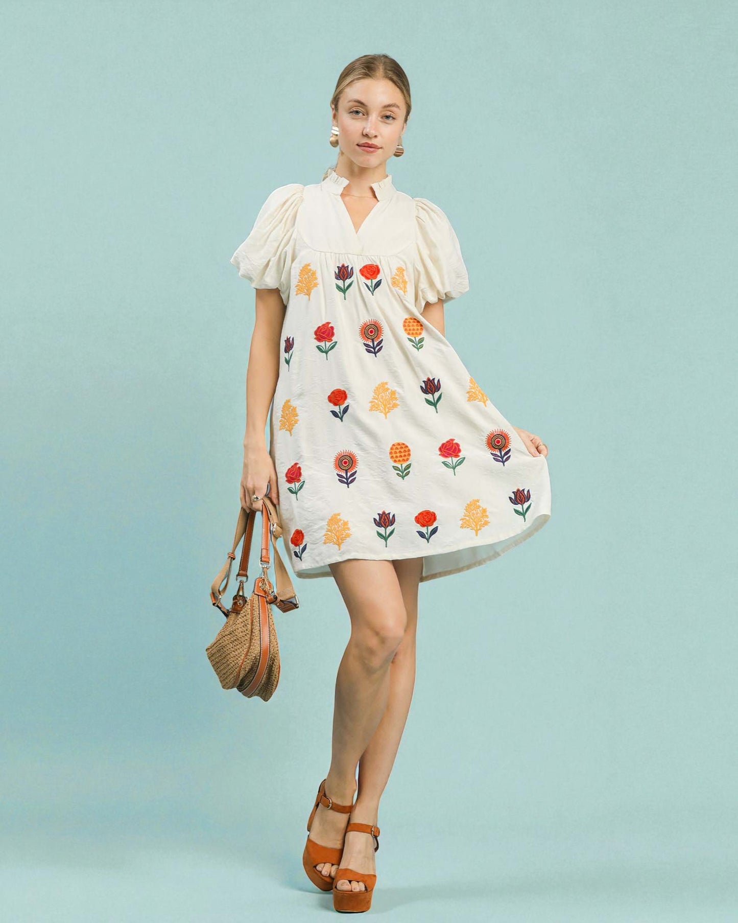 Woman wearing a floral dress on a light blue background