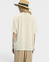 Person wearing a light-colored shirt and beige pants with a straw hat on a white background