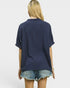 Person wearing a navy blue shirt and denim shorts on a white background