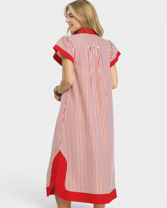 Woman wearing a red and white striped dress with red accents on a white background