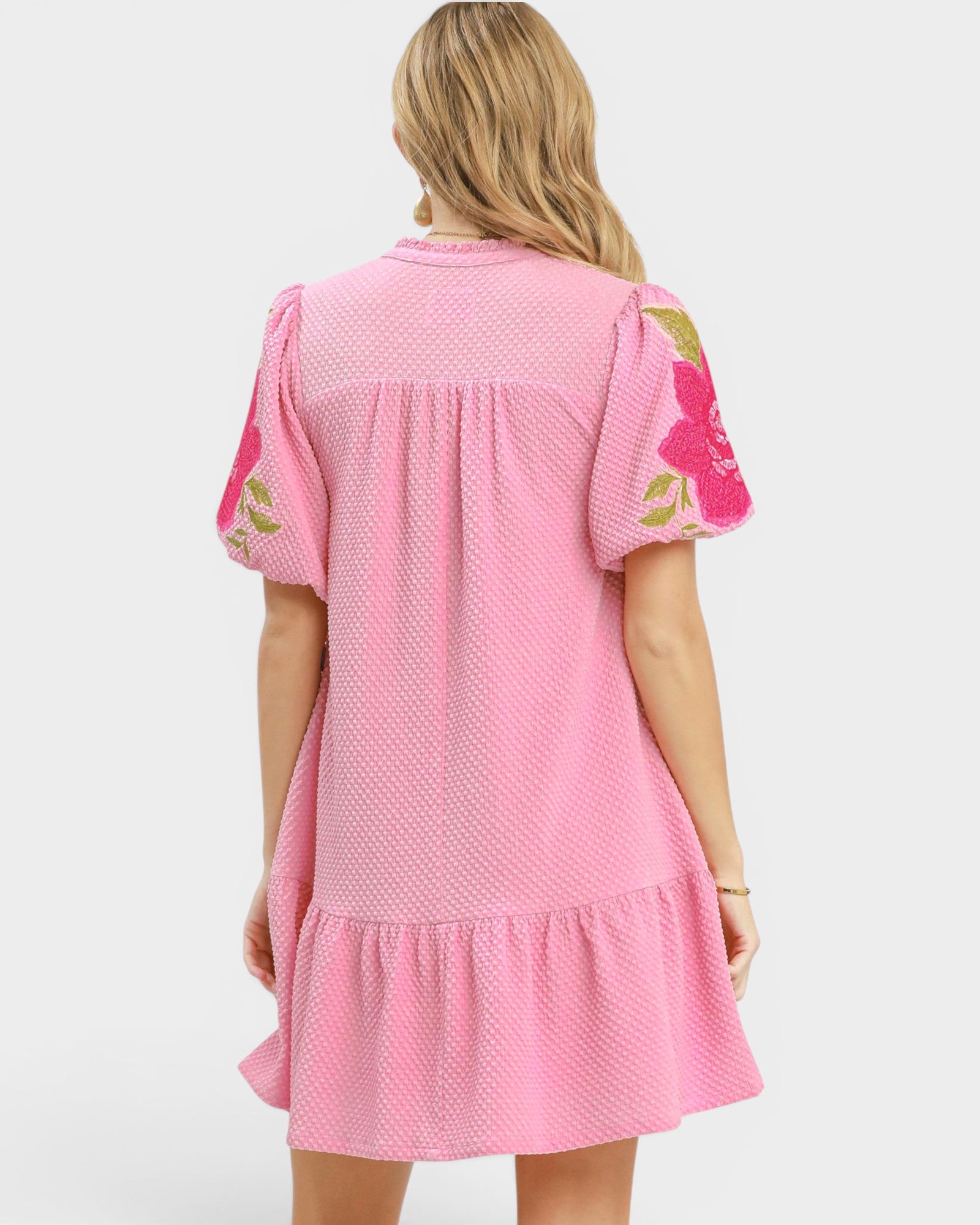 Pink dress with floral sleeves on a white background