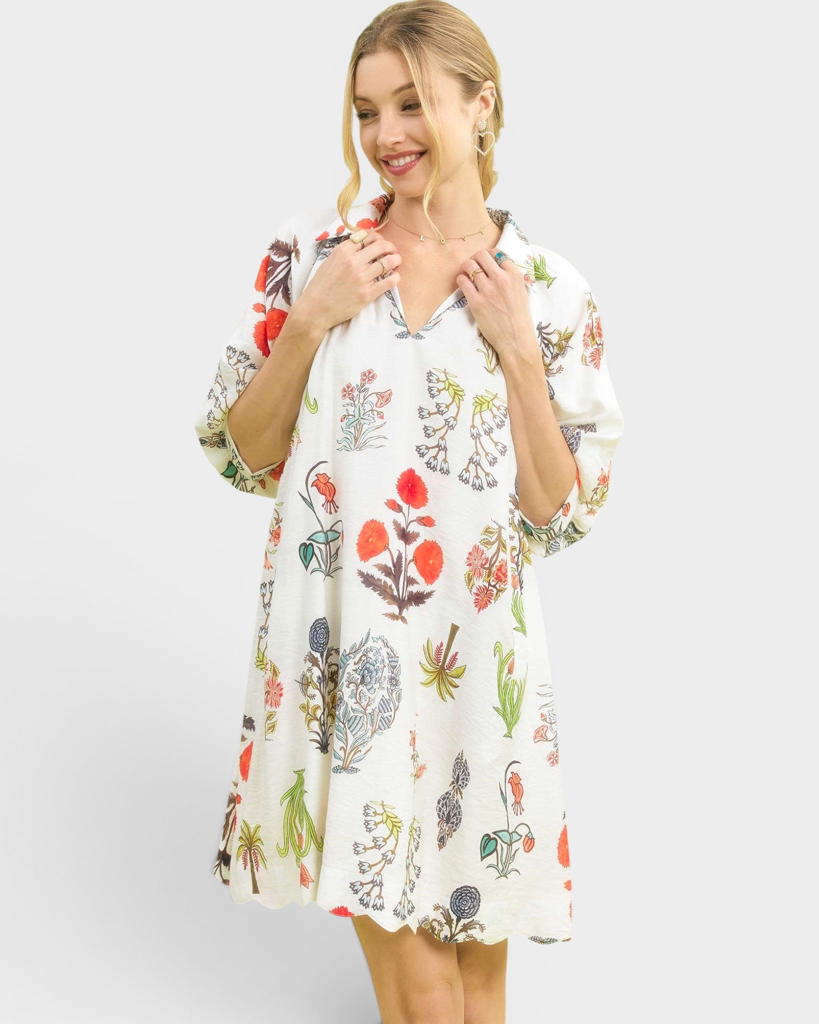 Woman wearing a floral patterned dress on a white background