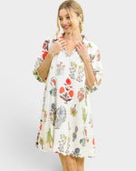 Woman wearing a floral patterned dress on a white background