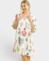 Woman wearing a floral patterned dress on a white background