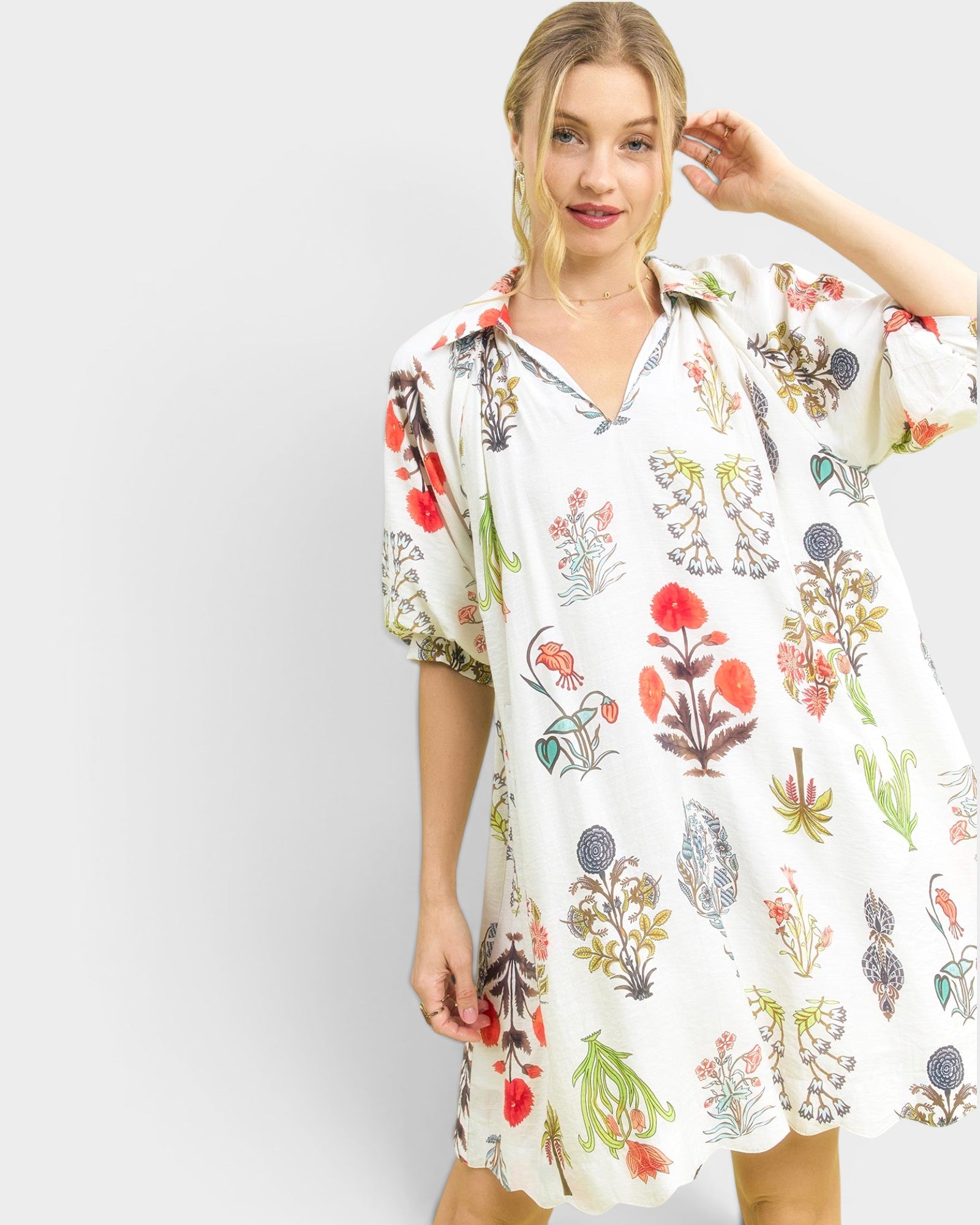 Woman wearing a floral dress against a white background