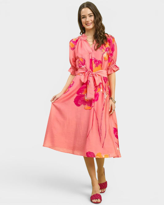 Woman wearing a pink floral dress on a white background