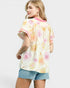 Woman wearing a floral kimono-style top with a white background