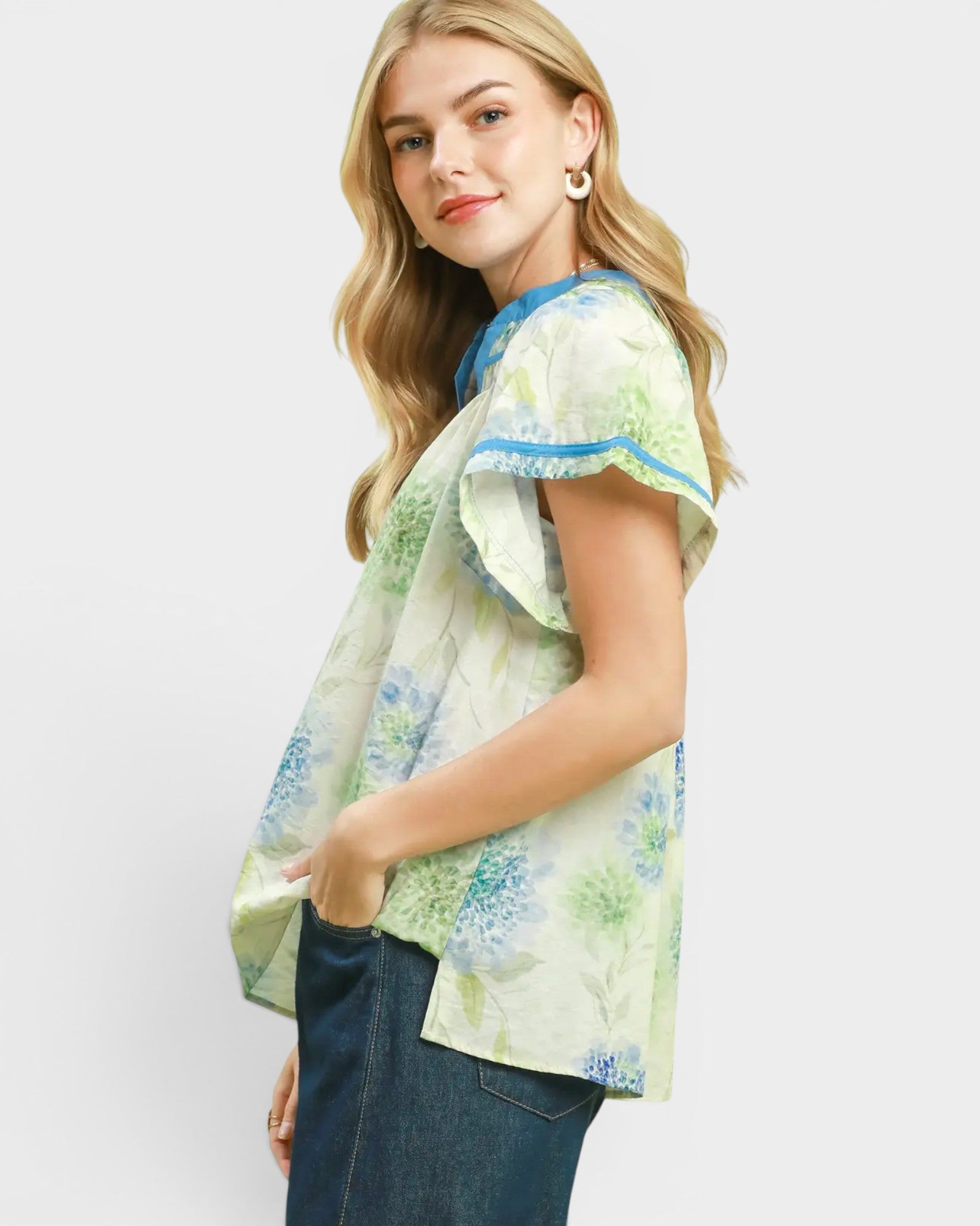 Woman wearing a floral blouse with a plain background