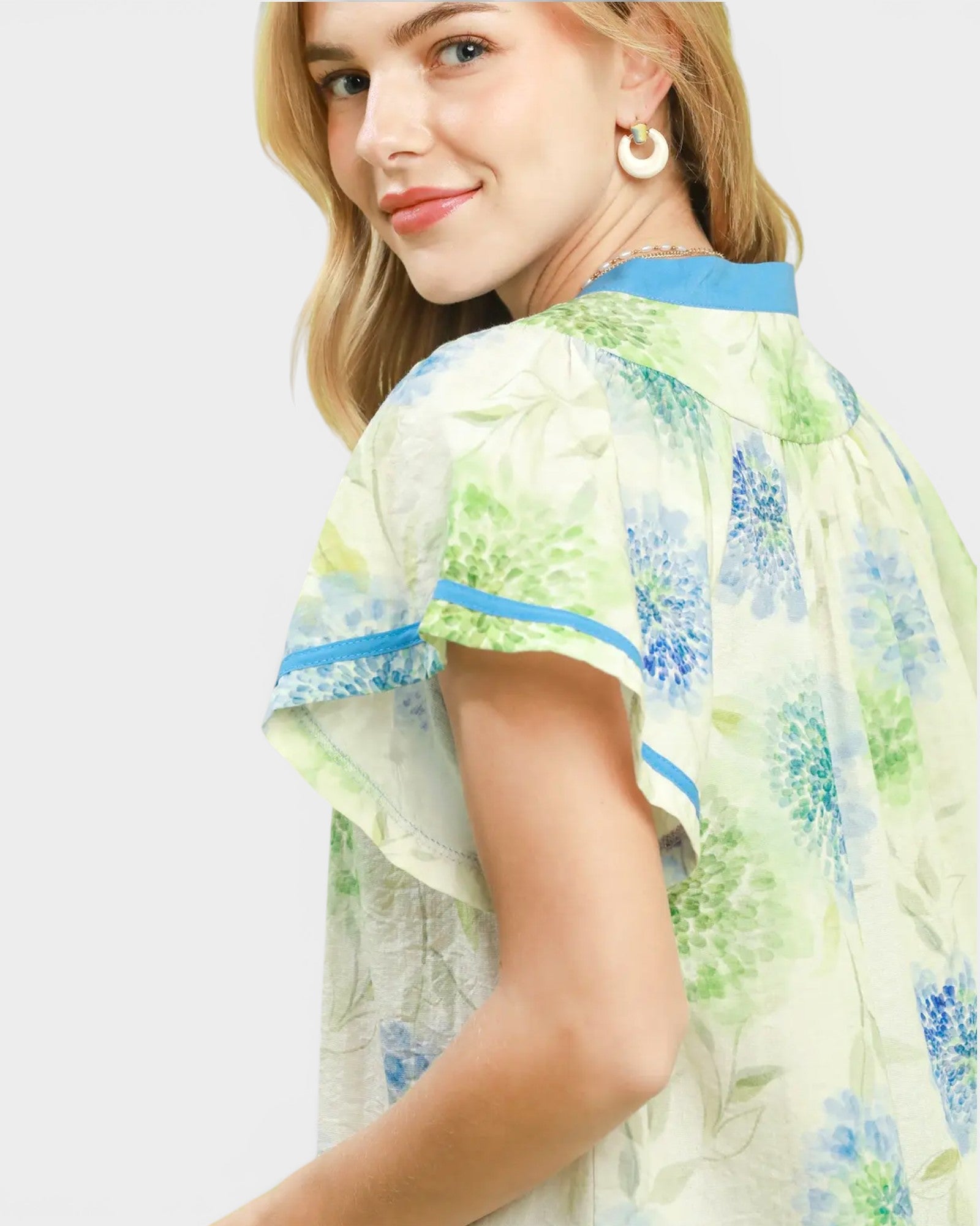 Woman wearing a floral dress with a white background