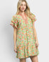 Woman wearing a green floral dress on a white background