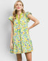 Woman wearing a colorful floral dress on a plain background