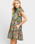 Woman wearing a colorful floral dress on a light gray background