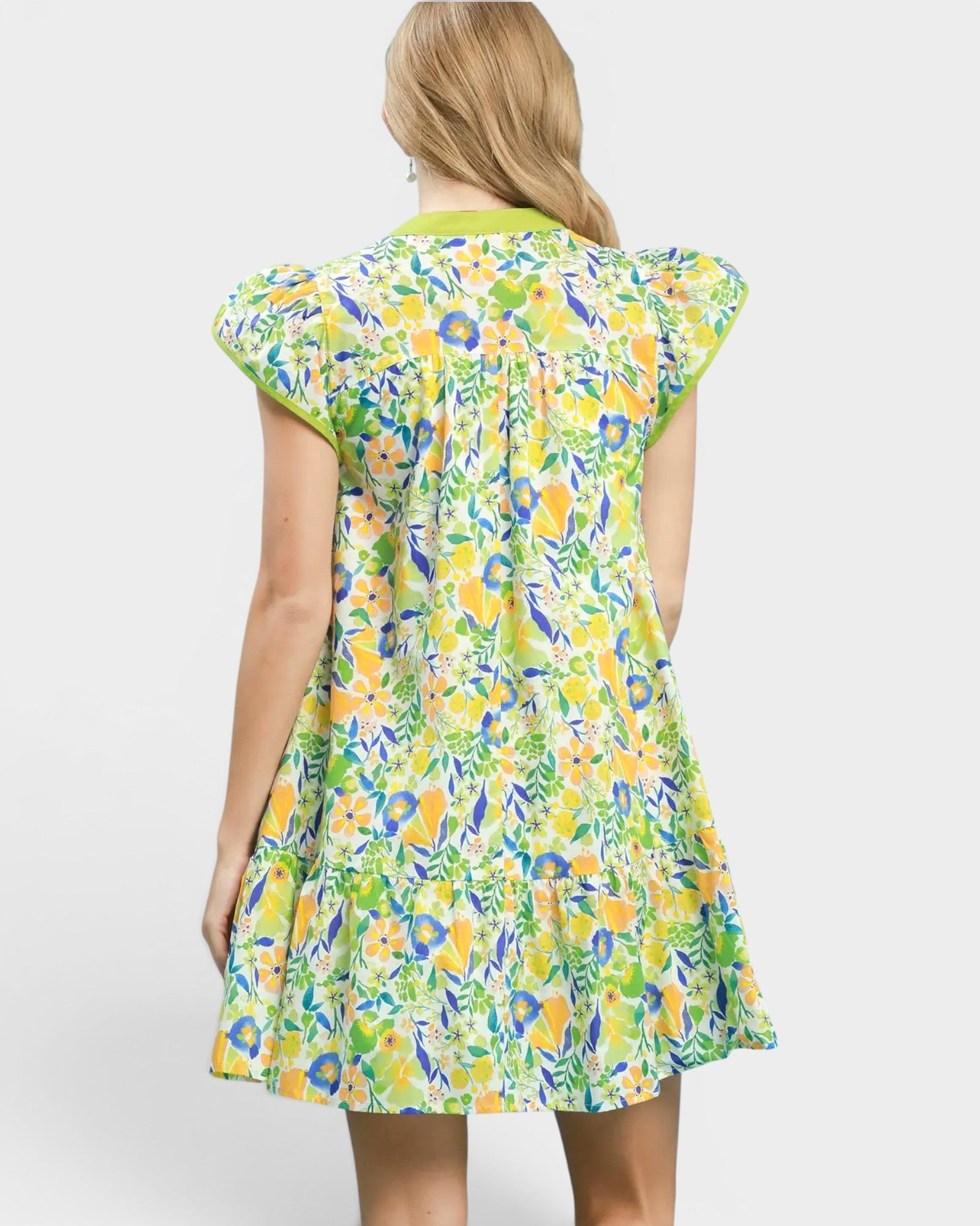 Woman wearing a colorful floral dress on a white background