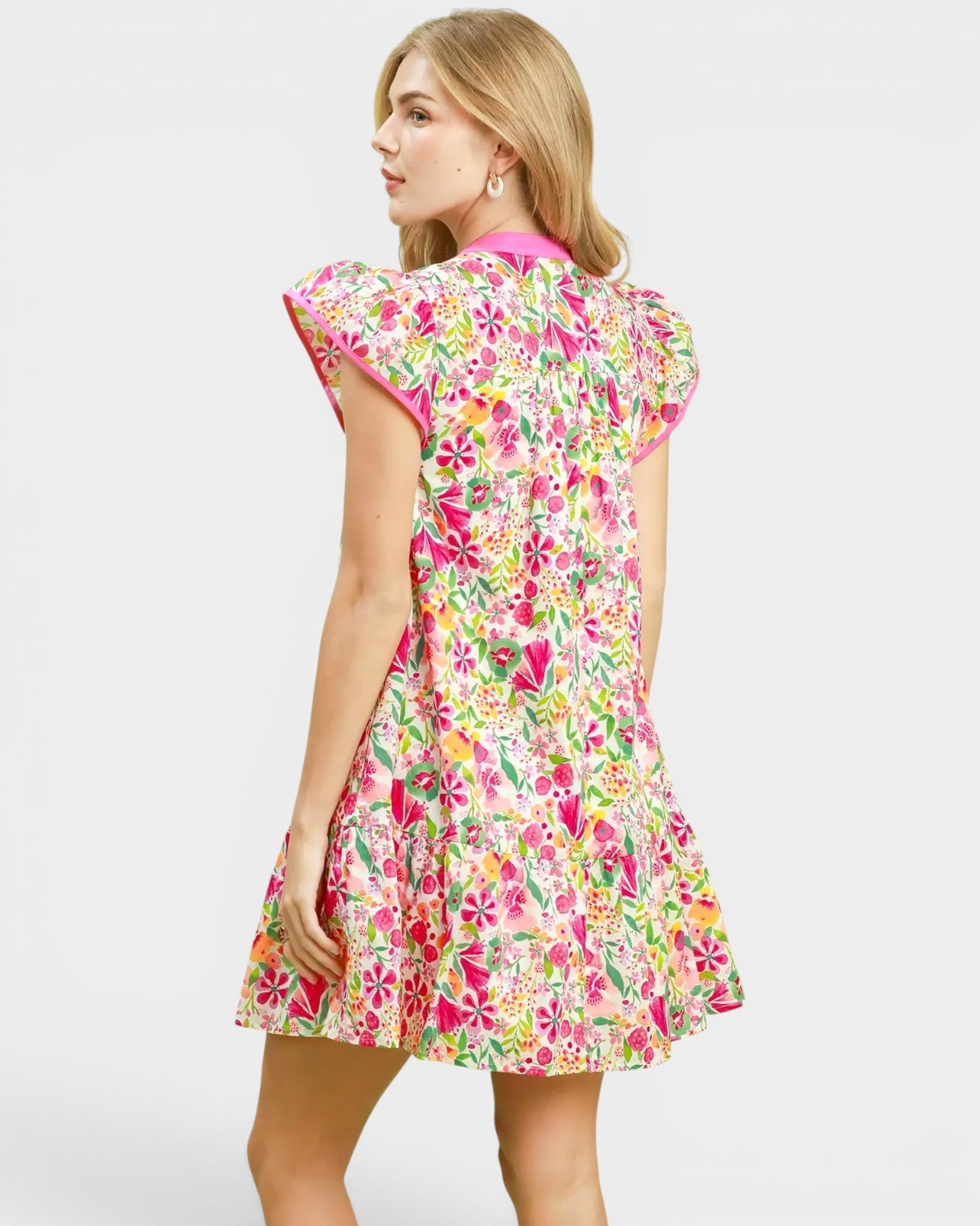 Woman wearing a colorful floral dress on a white background