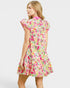 Woman wearing a colorful floral dress on a white background