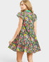 Woman wearing a colorful floral dress on a white background