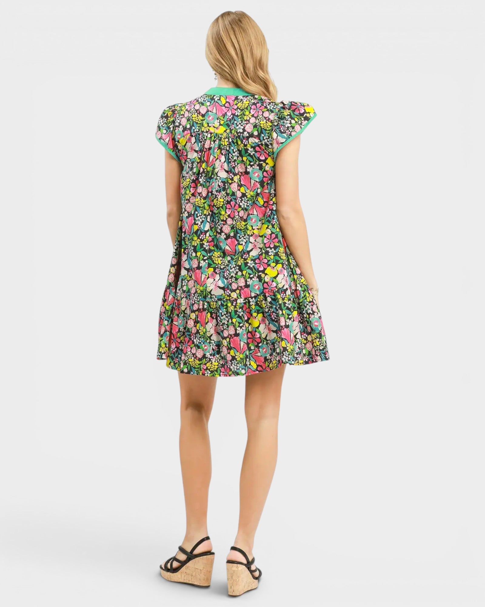 Woman wearing a colorful floral dress on a white background