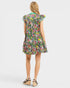 Woman wearing a colorful floral dress on a white background