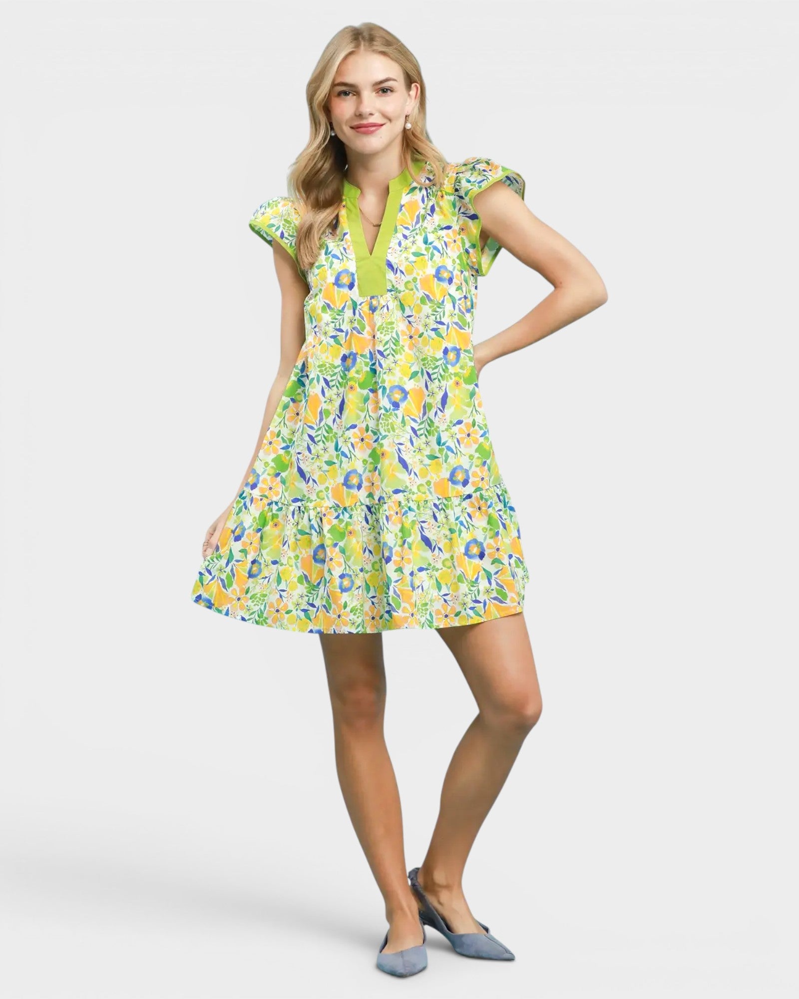 Woman wearing a colorful floral dress on a white background