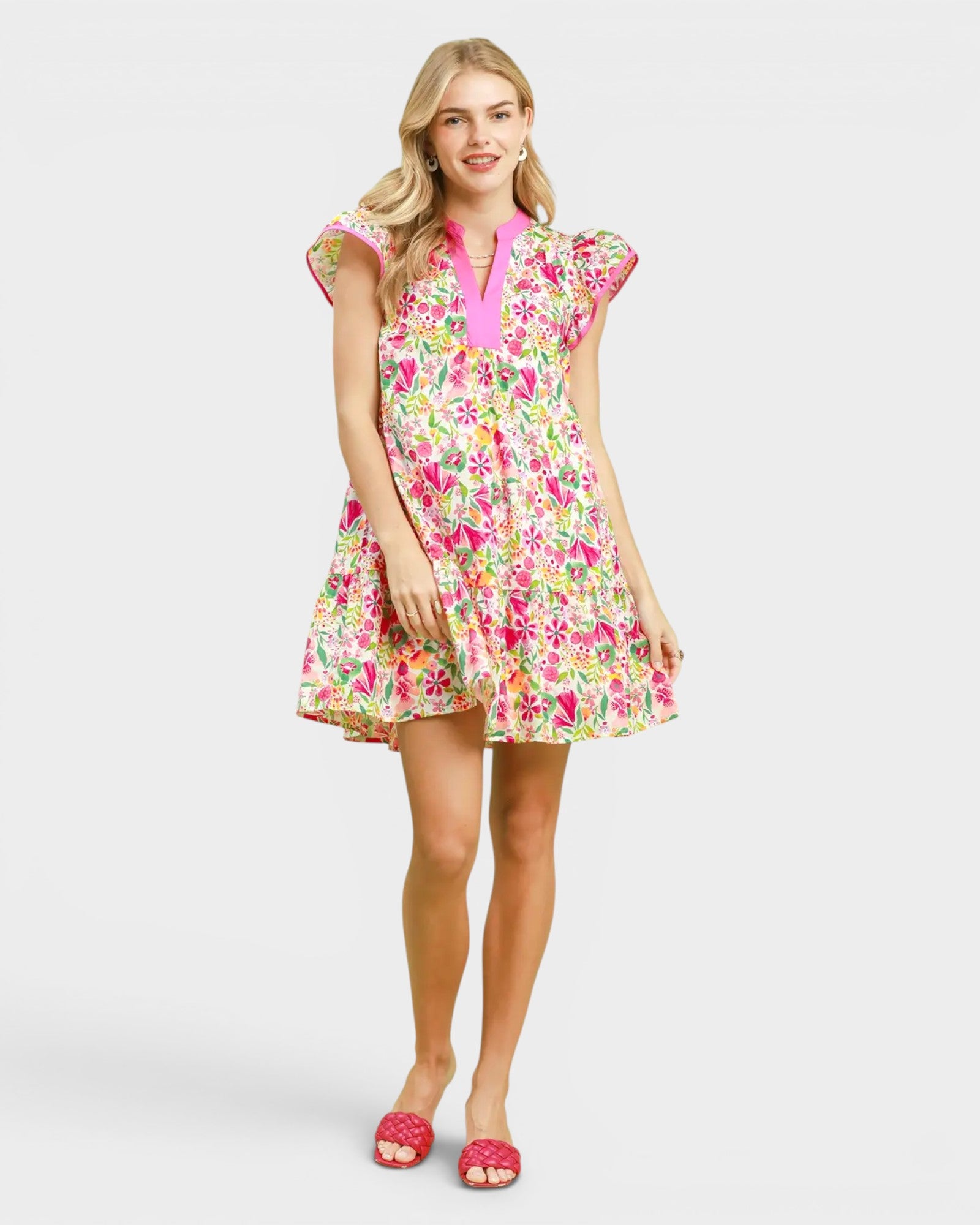 Woman wearing a colorful floral dress on a white background