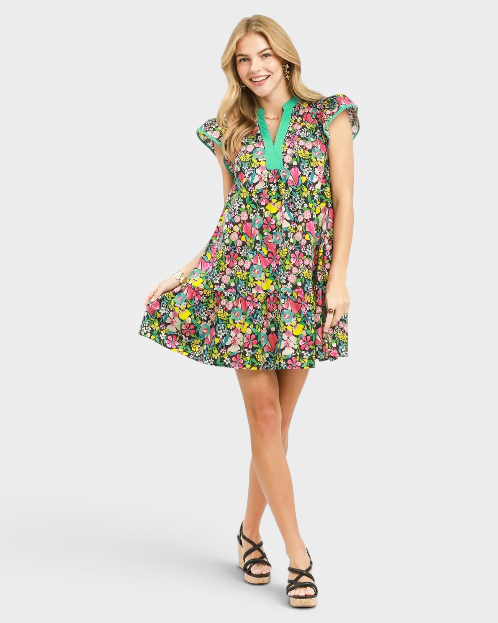 Woman wearing a colorful floral dress on a white background
