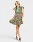 Woman wearing a colorful floral dress on a white background
